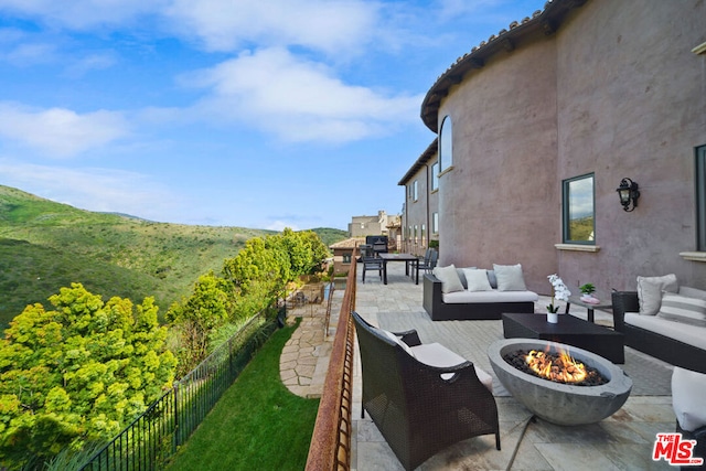 exterior space with an outdoor living space with a fire pit