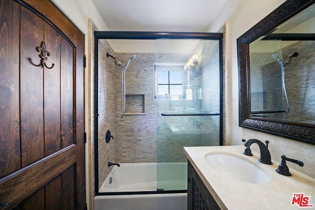 bathroom with vanity and combined bath / shower with glass door