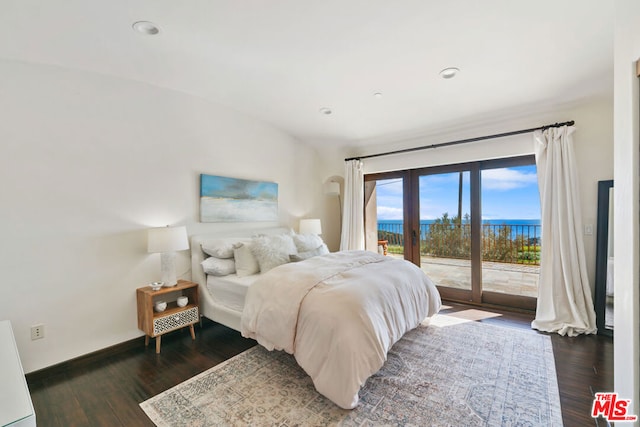 bedroom with access to exterior, dark hardwood / wood-style floors, french doors, and a water view