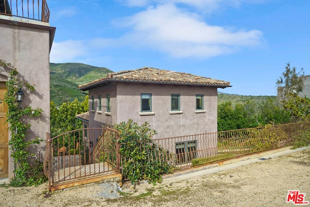 view of property exterior featuring a mountain view