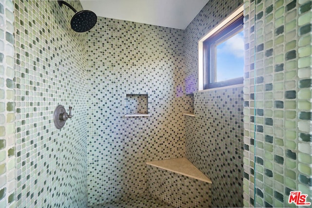 bathroom with a tile shower