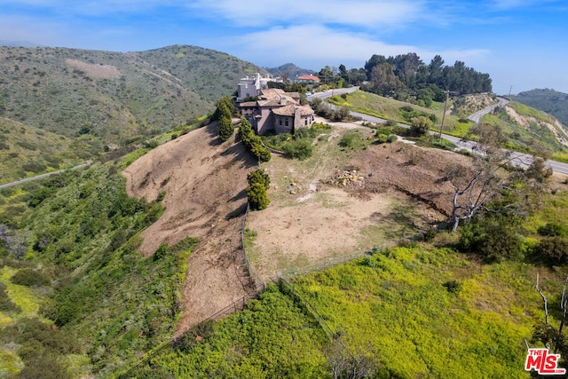 birds eye view of property with a mountain view