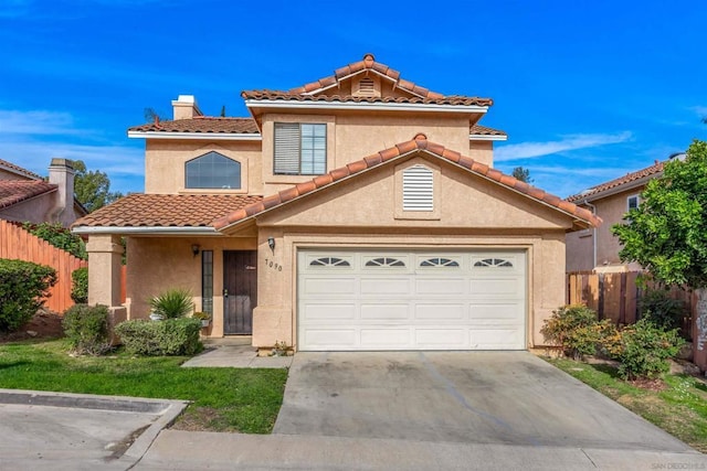 mediterranean / spanish house with a garage