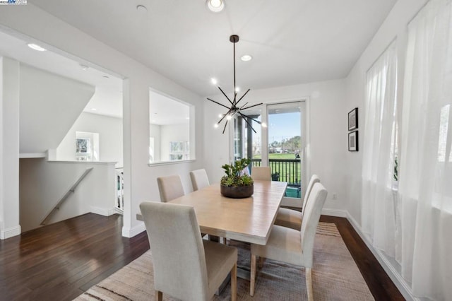 dining area featuring dark hardwood / wood-style flooring and a chandelier