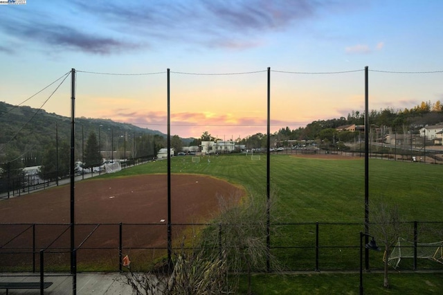 view of property's community with a mountain view and a lawn