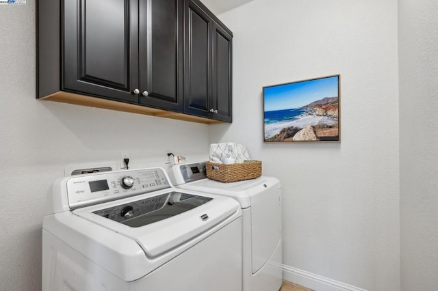 clothes washing area with cabinets and independent washer and dryer