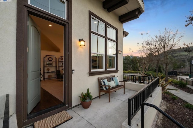 exterior entry at dusk with a porch