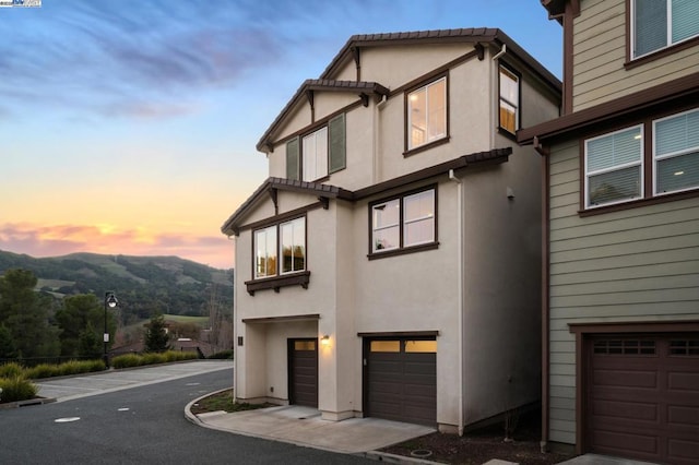 exterior space featuring a garage and a mountain view