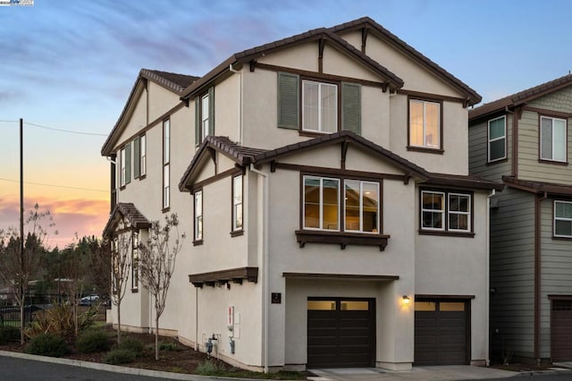 tudor-style house featuring a garage