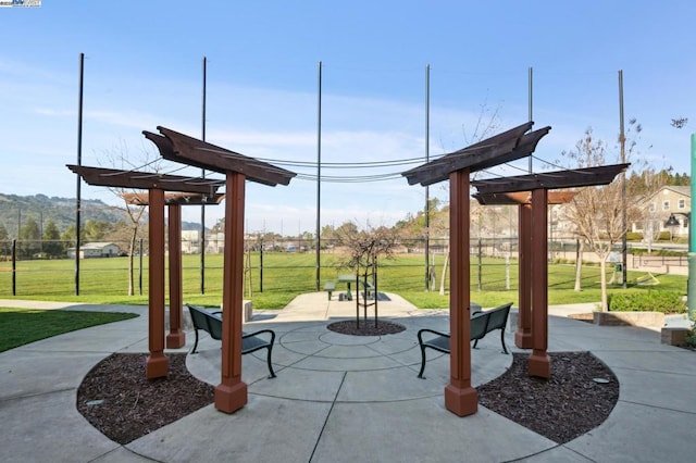 view of property's community with a patio and a lawn