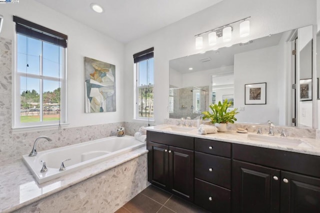 bathroom featuring tile patterned flooring, shower with separate bathtub, a wealth of natural light, and vanity