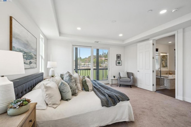 carpeted bedroom with connected bathroom, access to outside, and a raised ceiling