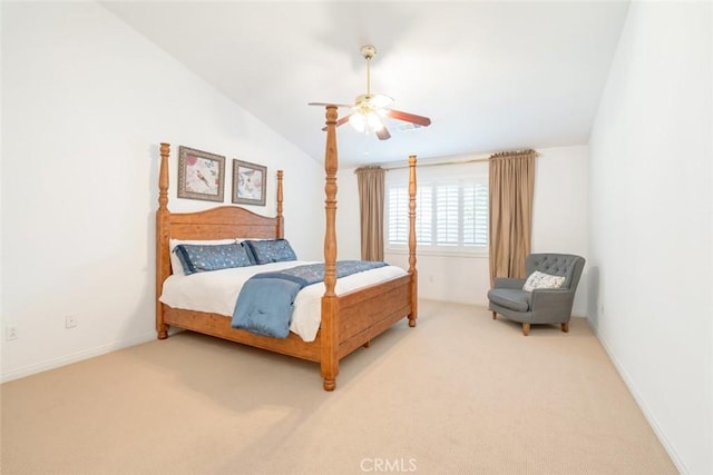 carpeted bedroom with ceiling fan and vaulted ceiling