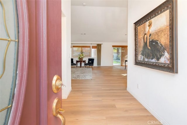 corridor with light hardwood / wood-style floors