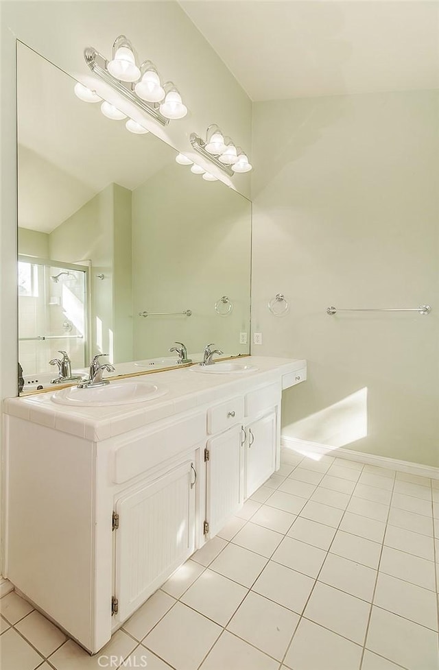 bathroom featuring tile patterned flooring, vanity, and a shower with shower door