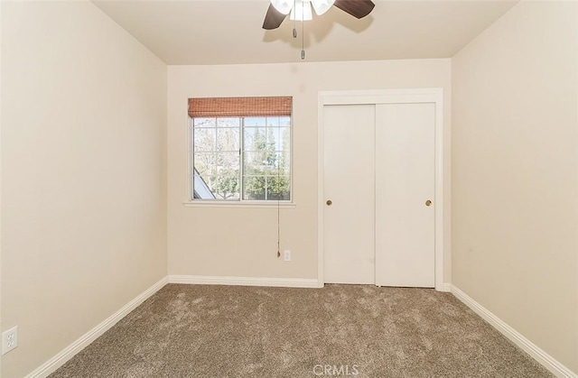 unfurnished bedroom featuring carpet, ceiling fan, and a closet