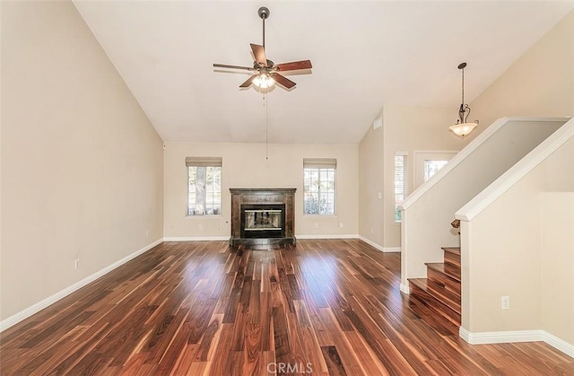 unfurnished living room with dark wood-type flooring, ceiling fan, and high vaulted ceiling