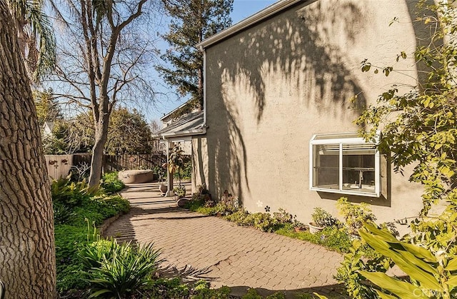 view of property exterior with a patio area