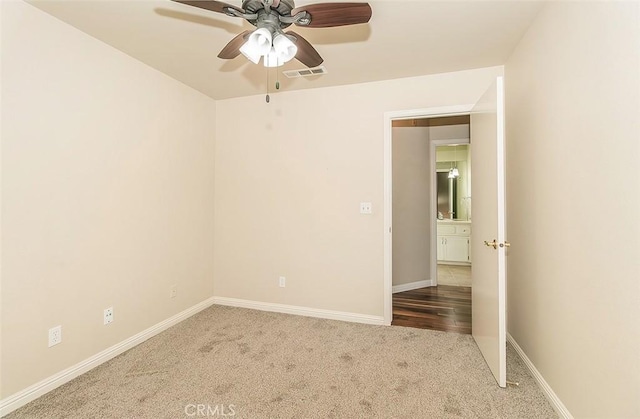 carpeted empty room with ceiling fan