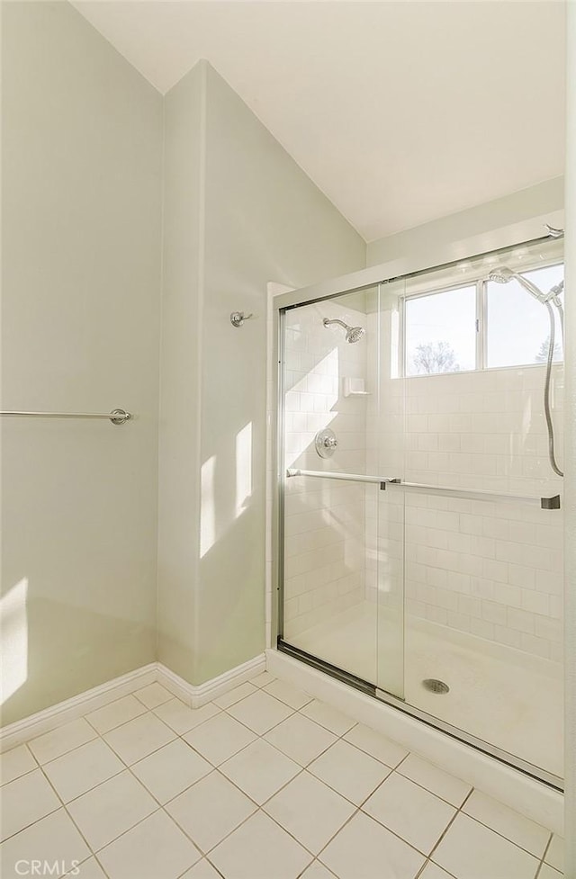 bathroom featuring tile patterned flooring and a shower with door