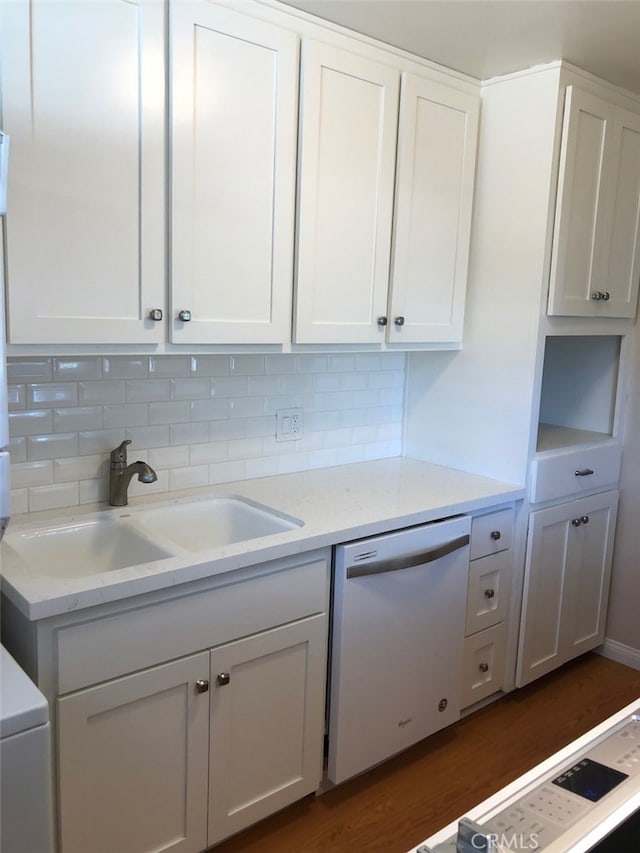 kitchen featuring sink, dishwasher, dark hardwood / wood-style floors, light stone counters, and white cabinets