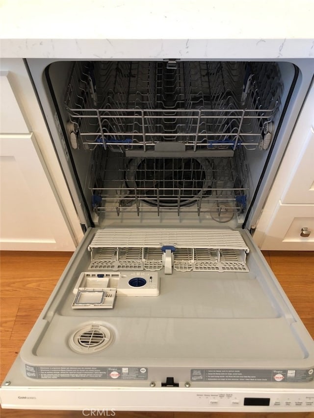 room details with white cabinetry and dishwasher