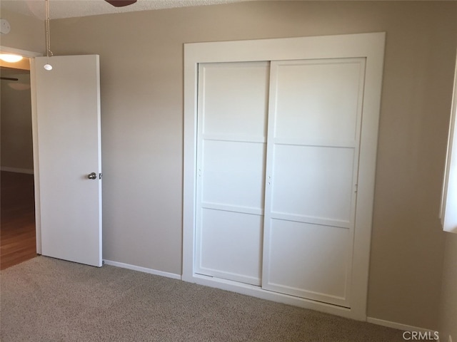 unfurnished bedroom with carpet flooring and a closet