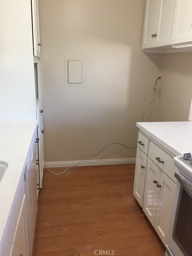 kitchen with dark wood-type flooring and white cabinets