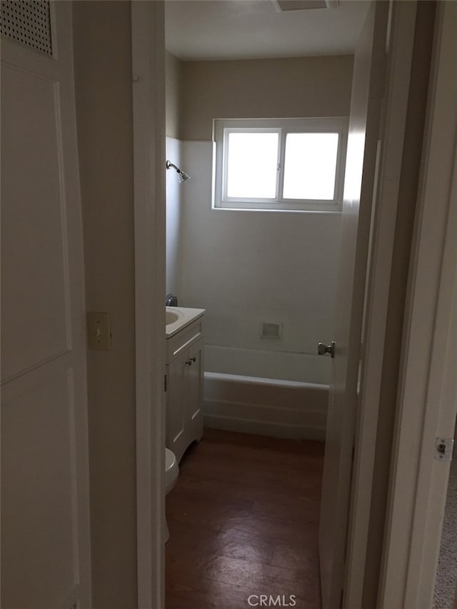 bathroom with vanity, toilet, and wood-type flooring