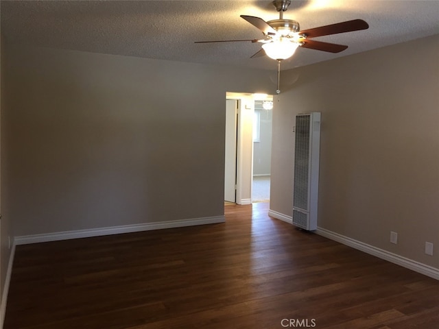 unfurnished room featuring ceiling fan, dark hardwood / wood-style flooring, and a textured ceiling