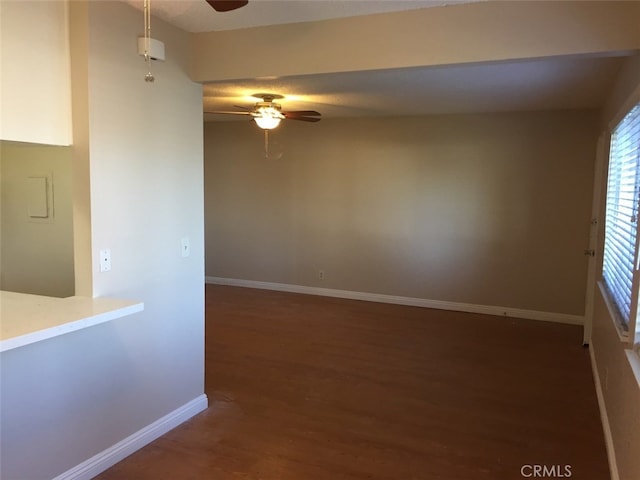 spare room featuring ceiling fan and dark hardwood / wood-style floors