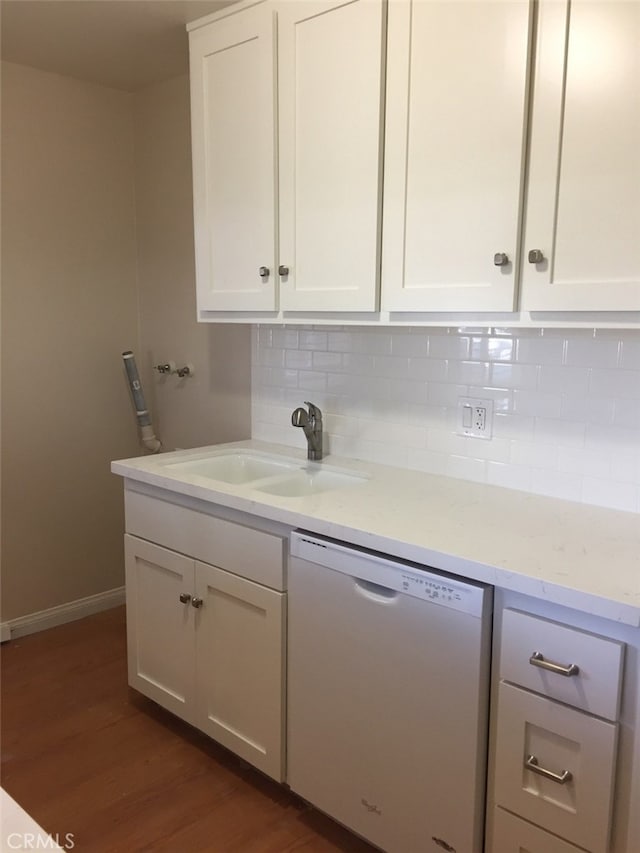 kitchen featuring sink, dishwasher, white cabinets, dark hardwood / wood-style flooring, and decorative backsplash