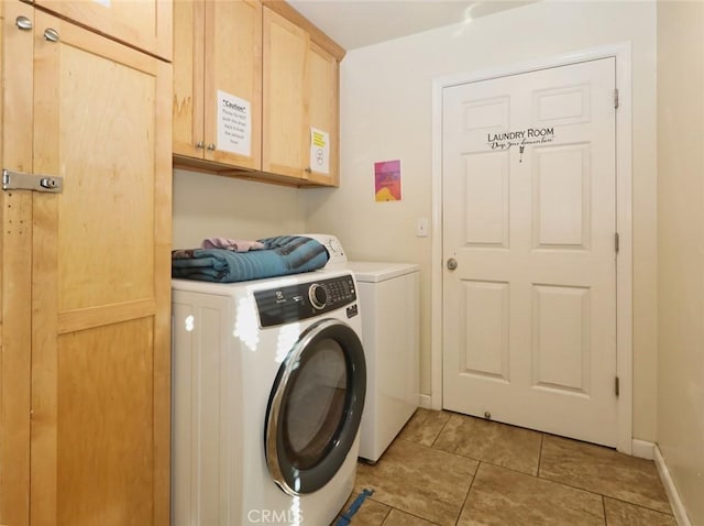 washroom with cabinets and washer and clothes dryer