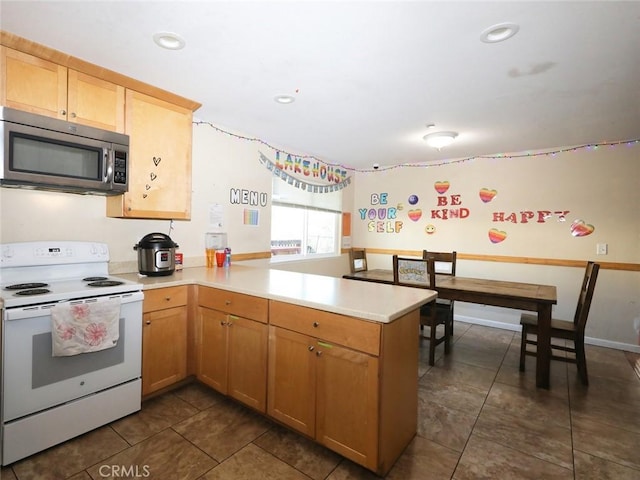 kitchen featuring kitchen peninsula and white range with electric stovetop