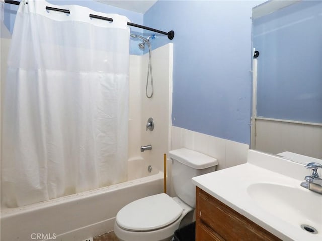 full bathroom featuring vanity, shower / bath combo with shower curtain, and toilet