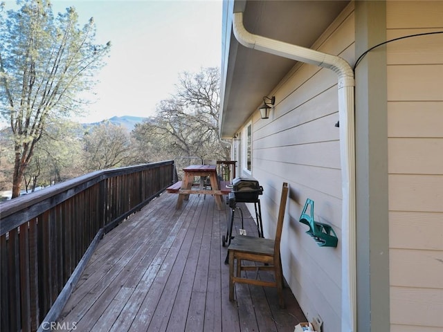 wooden deck with a mountain view