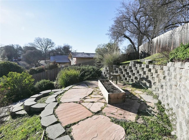 view of yard with a fenced backyard and a vegetable garden