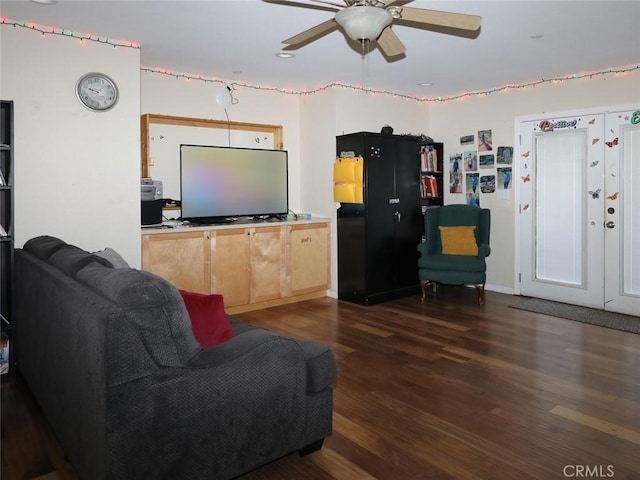 living room featuring dark hardwood / wood-style floors and ceiling fan