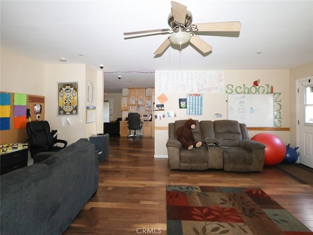 living room featuring dark wood-type flooring and ceiling fan