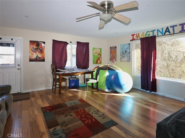 interior space featuring wood-type flooring and ceiling fan