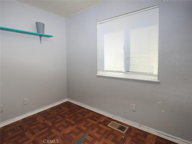 empty room featuring dark parquet floors