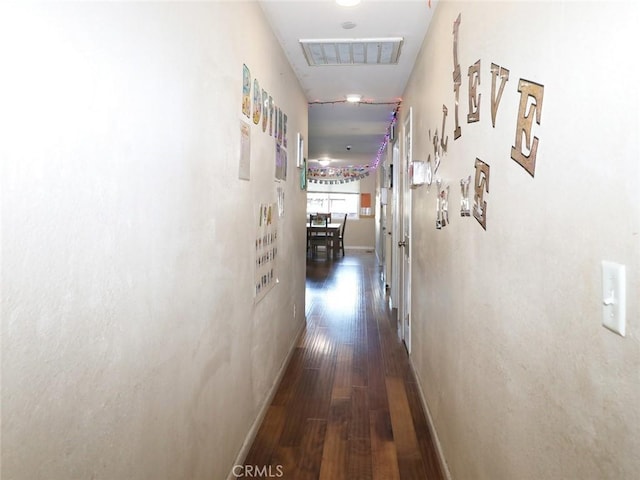 hallway with dark hardwood / wood-style flooring