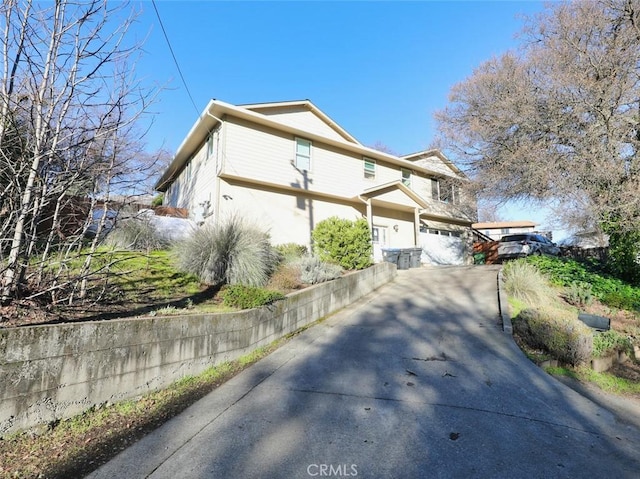 view of home's exterior with a garage and concrete driveway