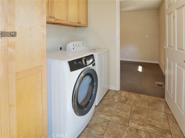 clothes washing area with light carpet, cabinet space, light tile patterned floors, visible vents, and separate washer and dryer