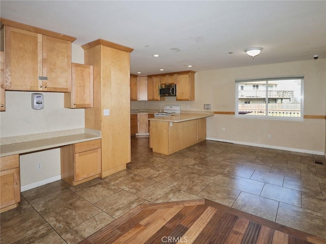 kitchen featuring white range with electric stovetop, baseboards, stainless steel microwave, a peninsula, and light countertops