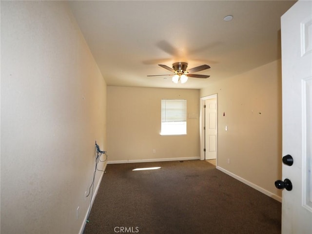 spare room featuring carpet flooring, ceiling fan, and baseboards