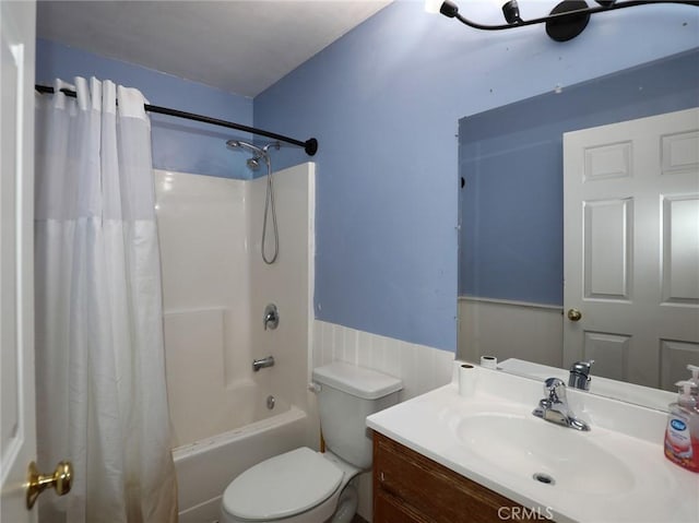 bathroom featuring toilet, shower / tub combo, and vanity