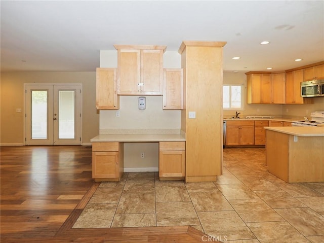 kitchen with electric range, stainless steel microwave, light countertops, french doors, and light brown cabinets