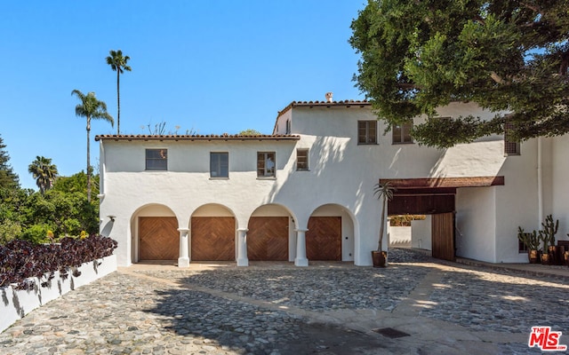 mediterranean / spanish house with a garage