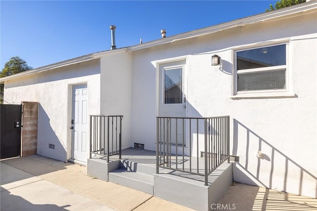 property entrance featuring a patio area